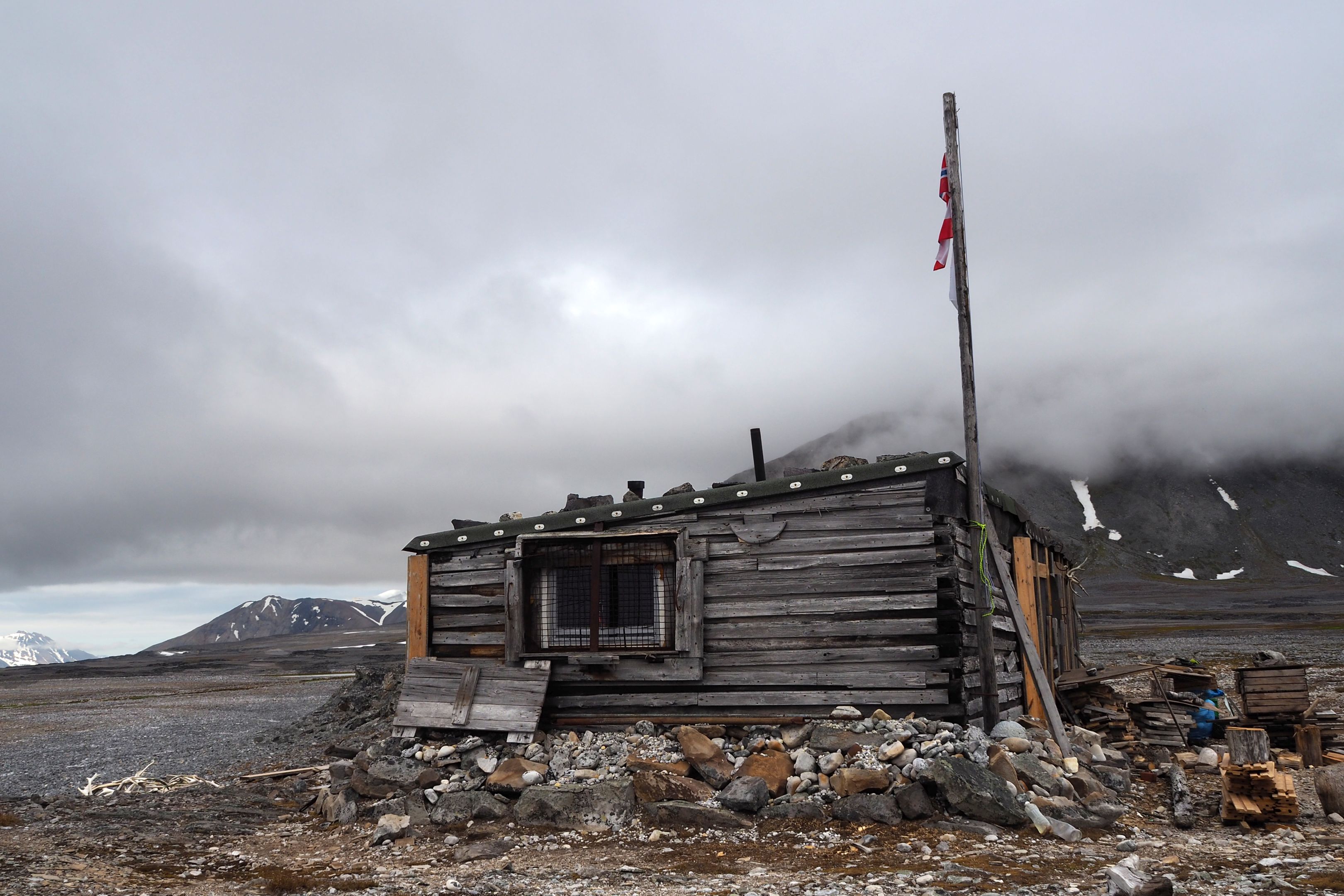 Old wooden cabin on a rocky landscape in Svalbard. 