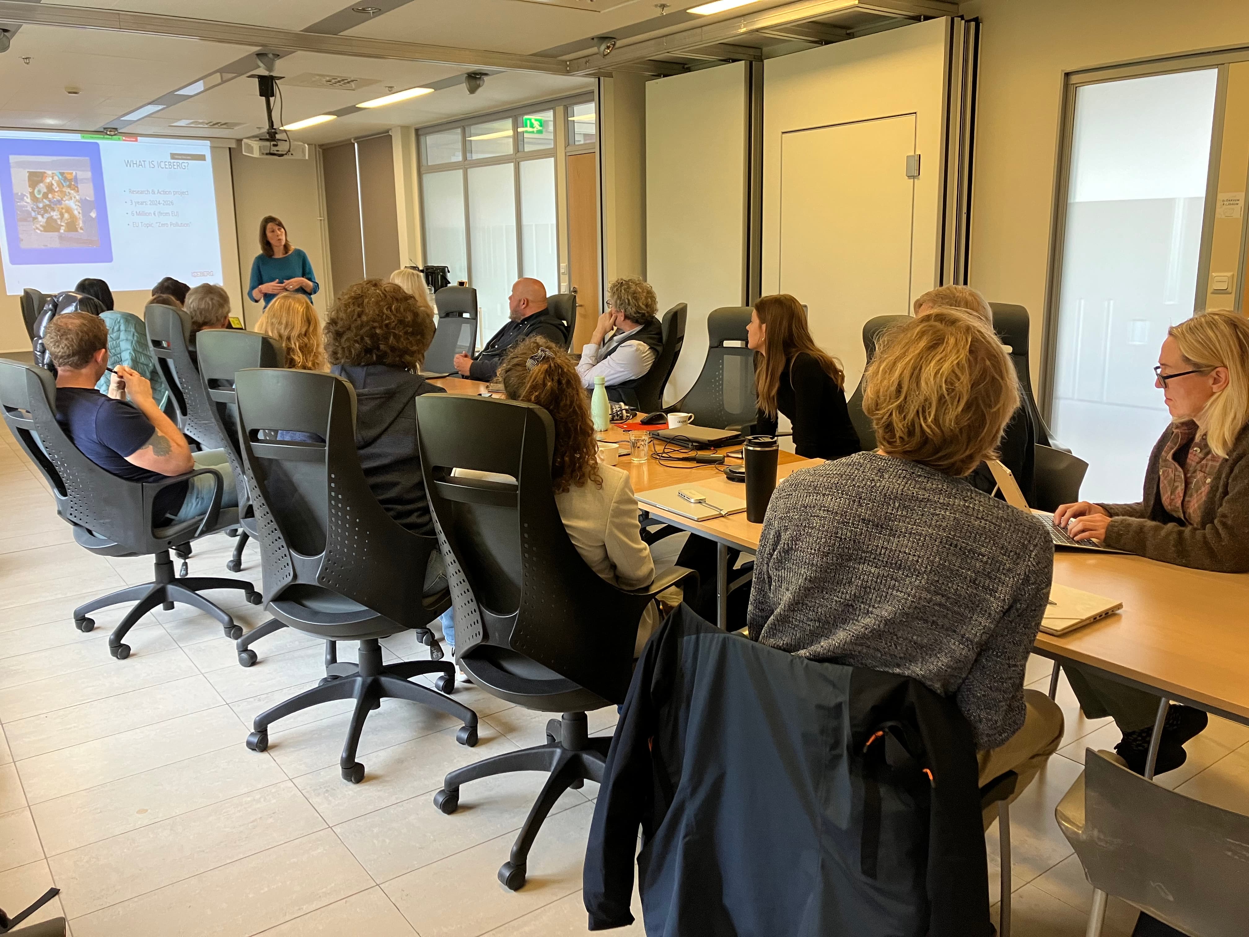 People sitting in a small conference room.