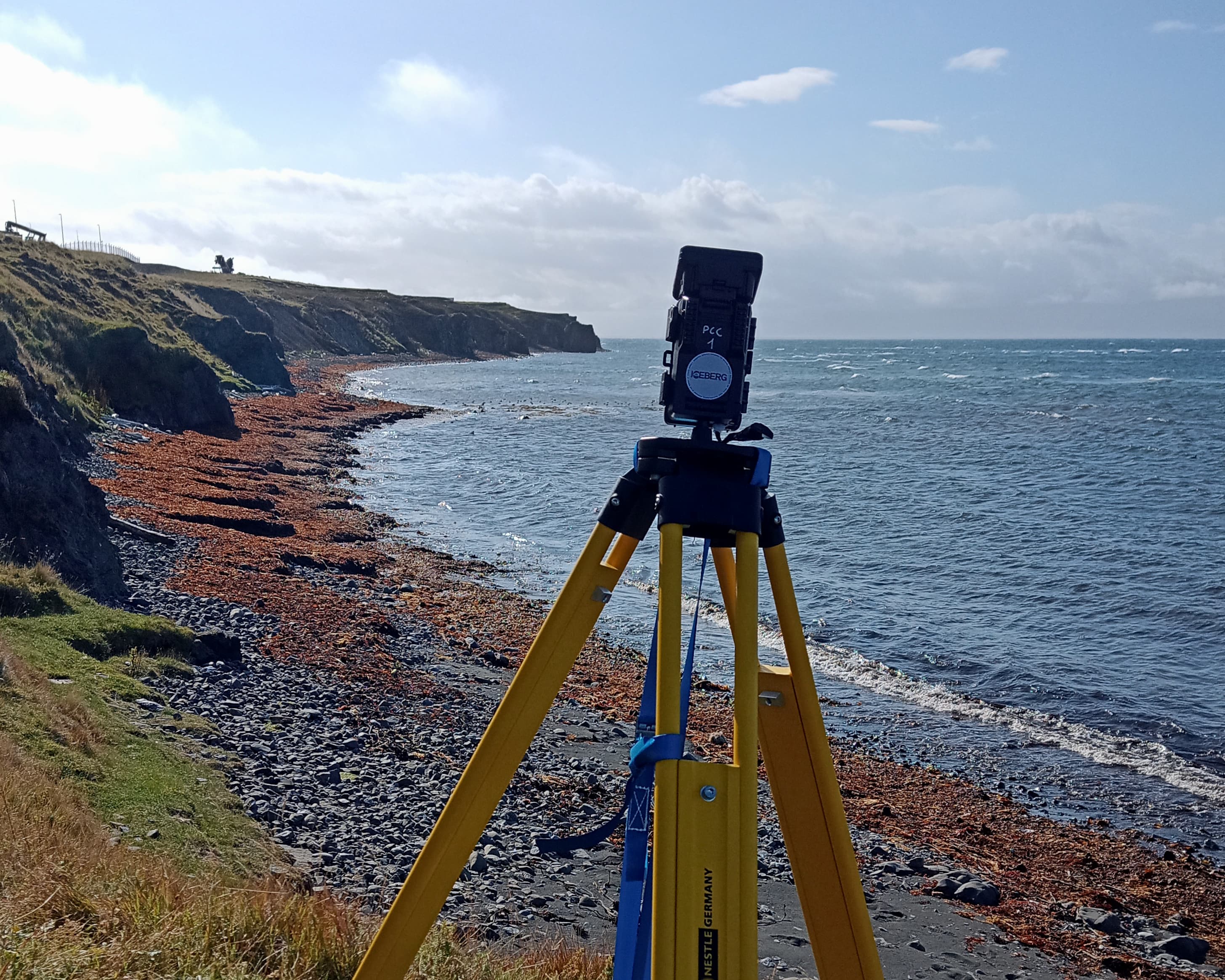 A time-lapse camera on a rocky beach.