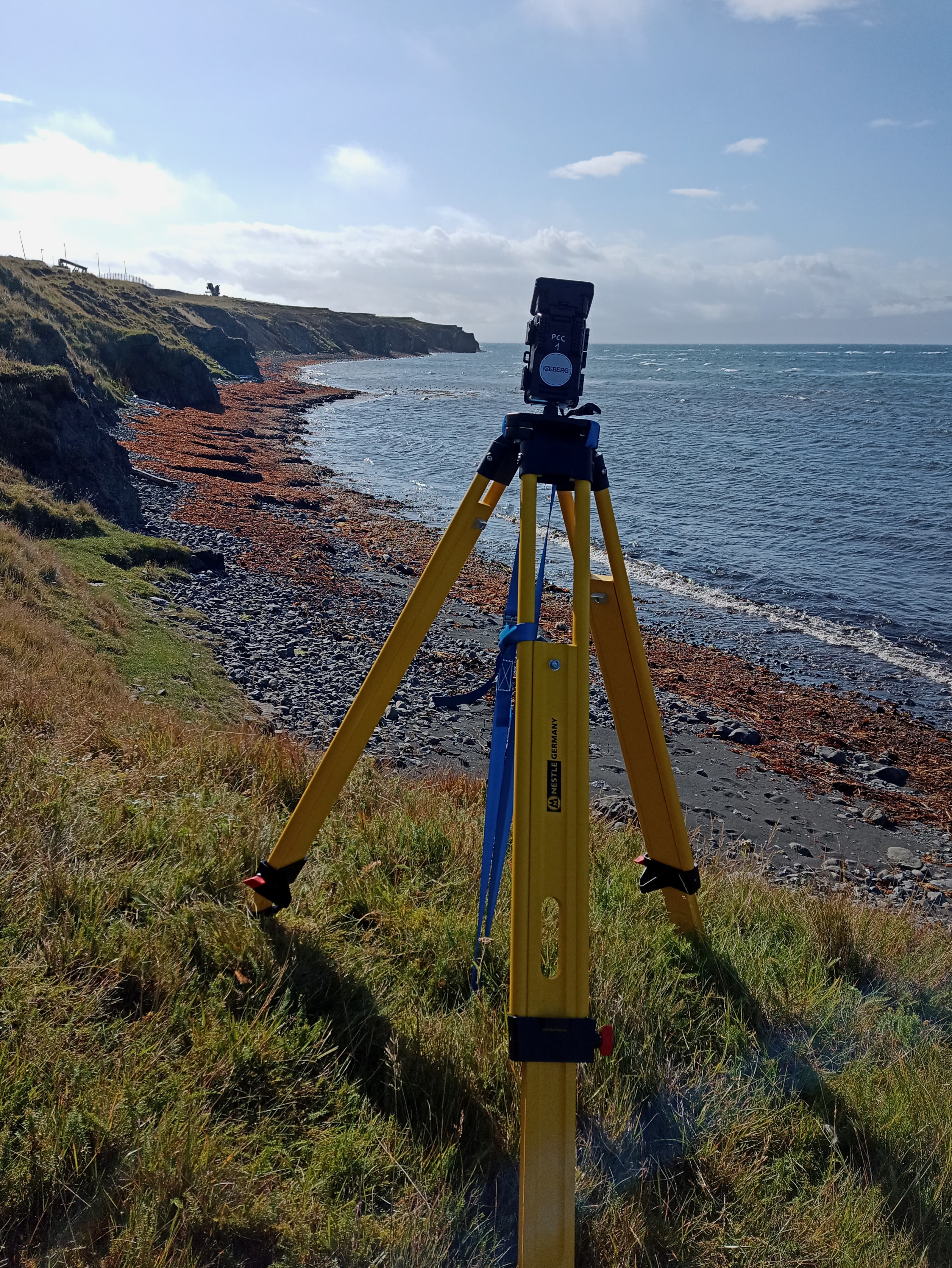 A time-lapse camera on a rocky beach.