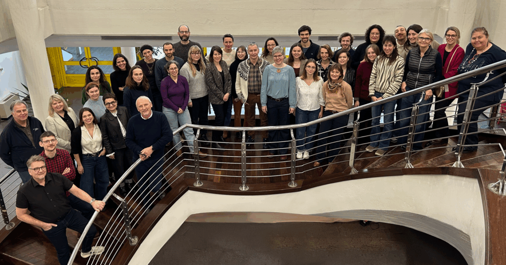 Group photo of 30+ ICEBERG project members on a staircase.