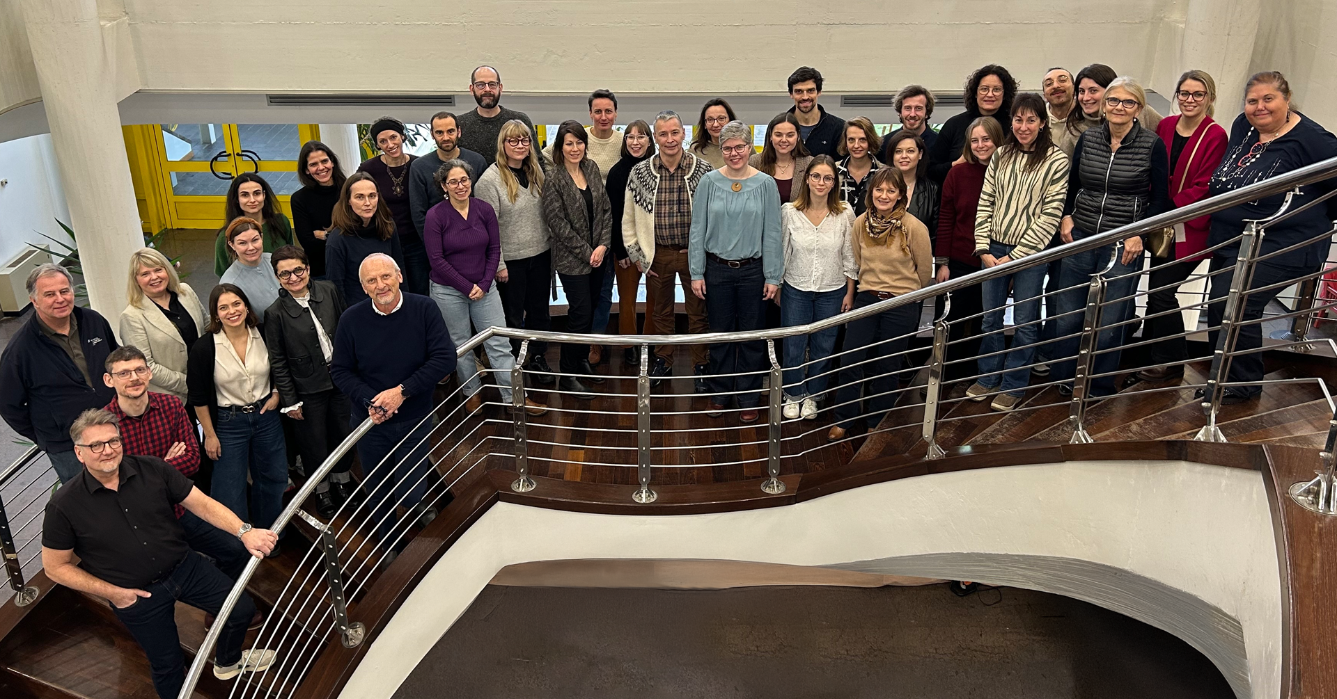 Group photo of 30+ ICEBERG project members on a staircase.