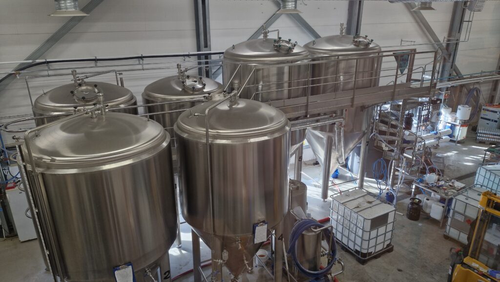 A brewery with enormous metal containers of water.